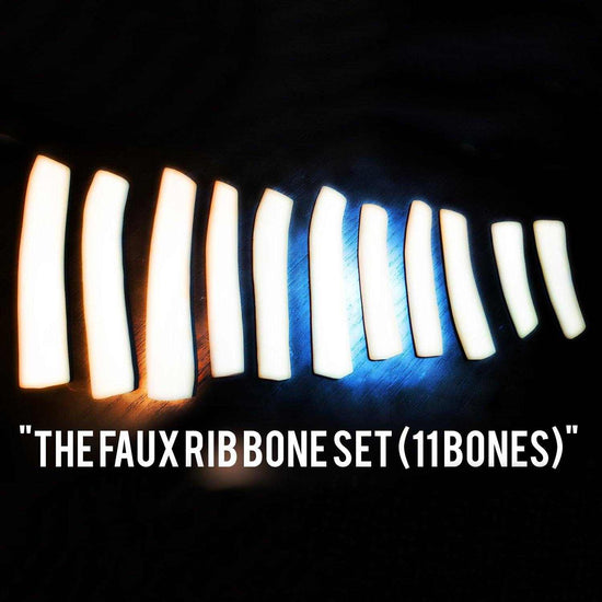 Set of 11 faux rib bones for plant-based meat alternatives, illuminated against a dark background