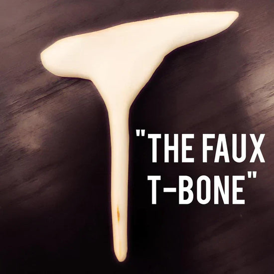 Close-up of a Faux T-Bone Mini Bulk wooden replica bone for plant-based meat dishes on a dark surface with text "THE FAUX T-BONE"